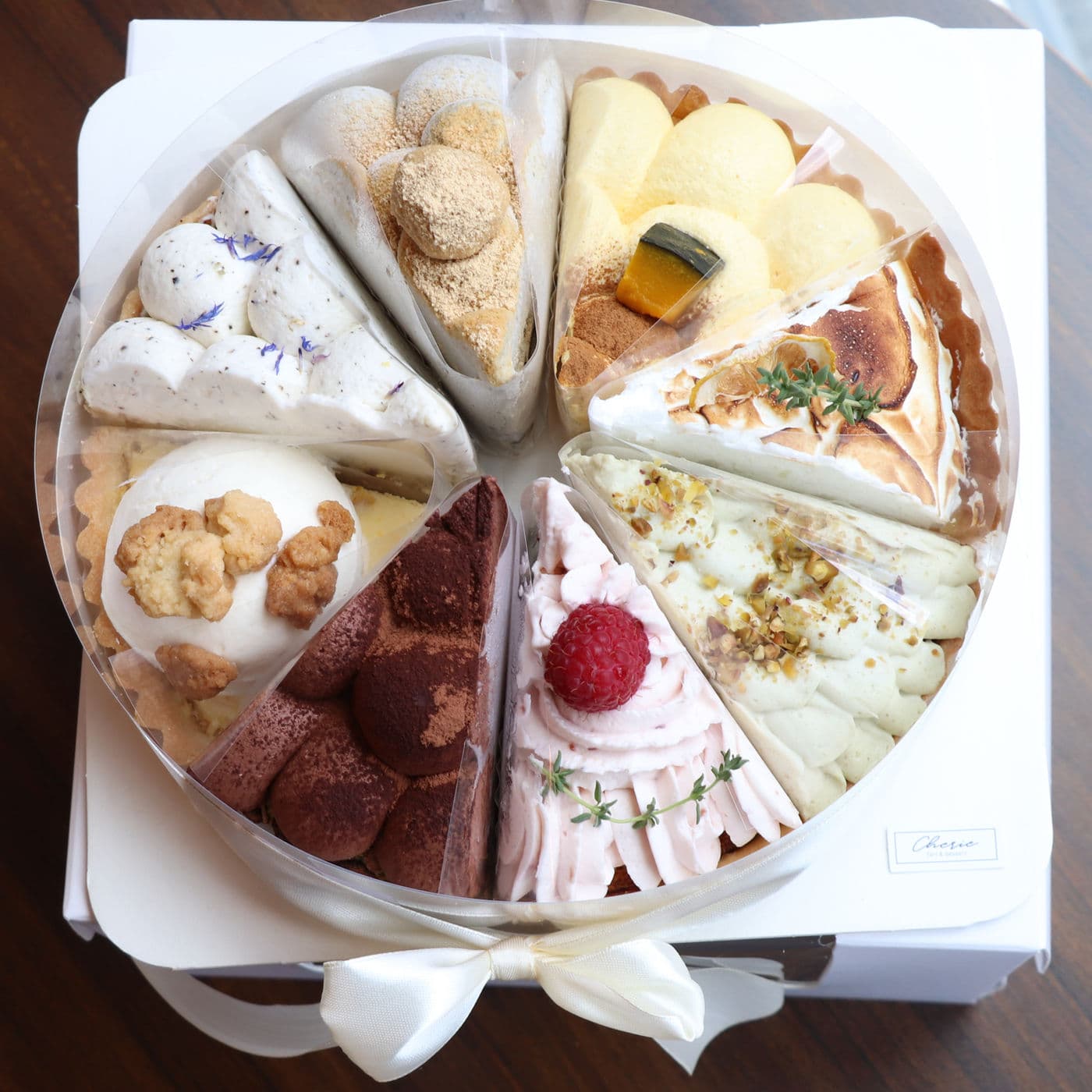 Assorted box of eight tart slices tied with ribbon